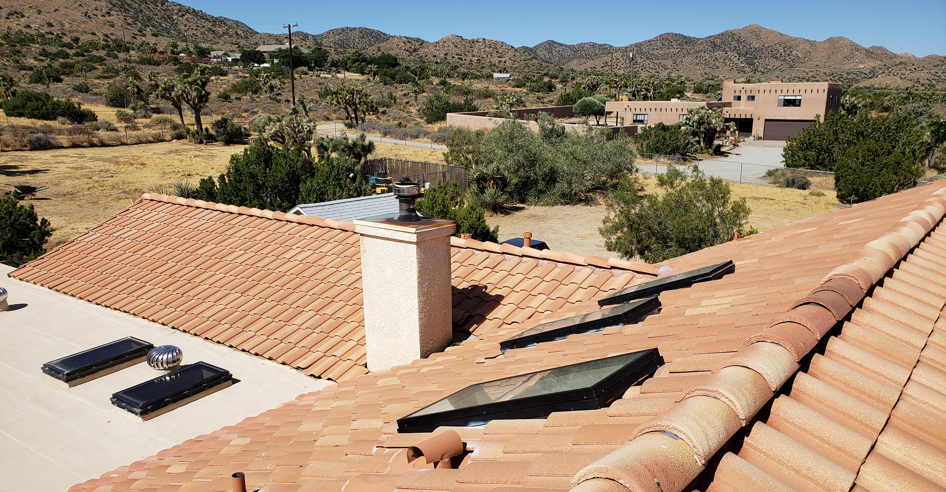 Roofworks professional installation of diverse new roof styles, including custom clay tile and energy-efficient designs in the Morongo Basin.