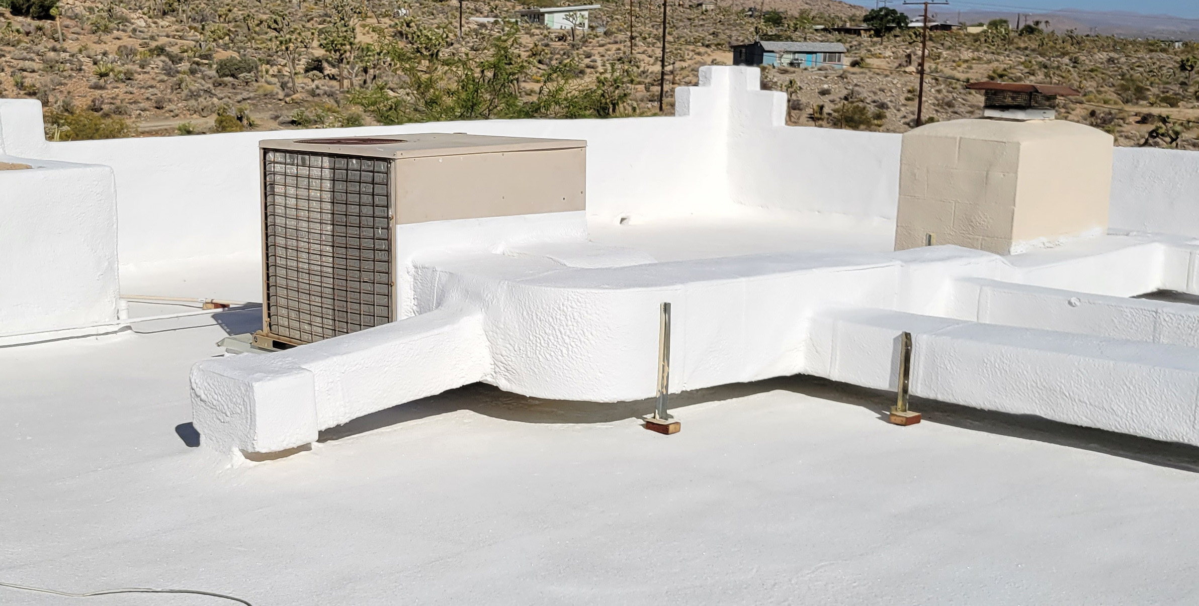 Professional flat and foam roof sealing and coating services by Roofworks, featuring a clean white energy-efficient finish.